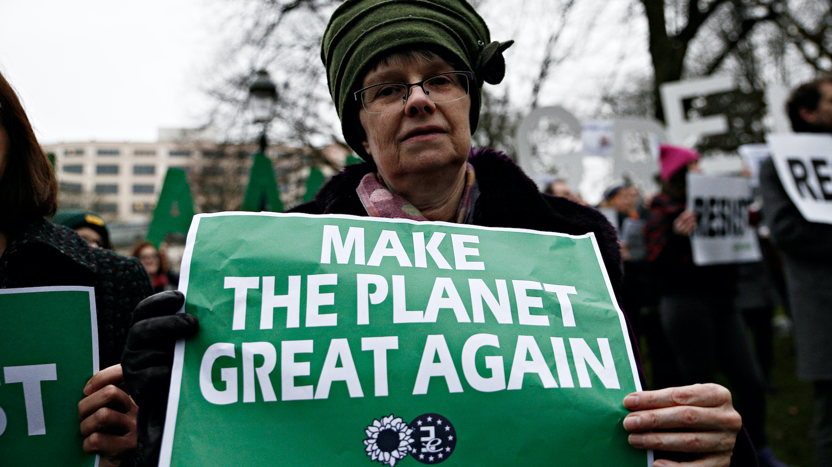 People hold placards and shout slogans during a protest against Donald Trump's environmental policy at conference attended by Trump climate advisor Myron Ebell in Brussels, Belgium on Feb. 2017. Photo: Alexandros Michailidis