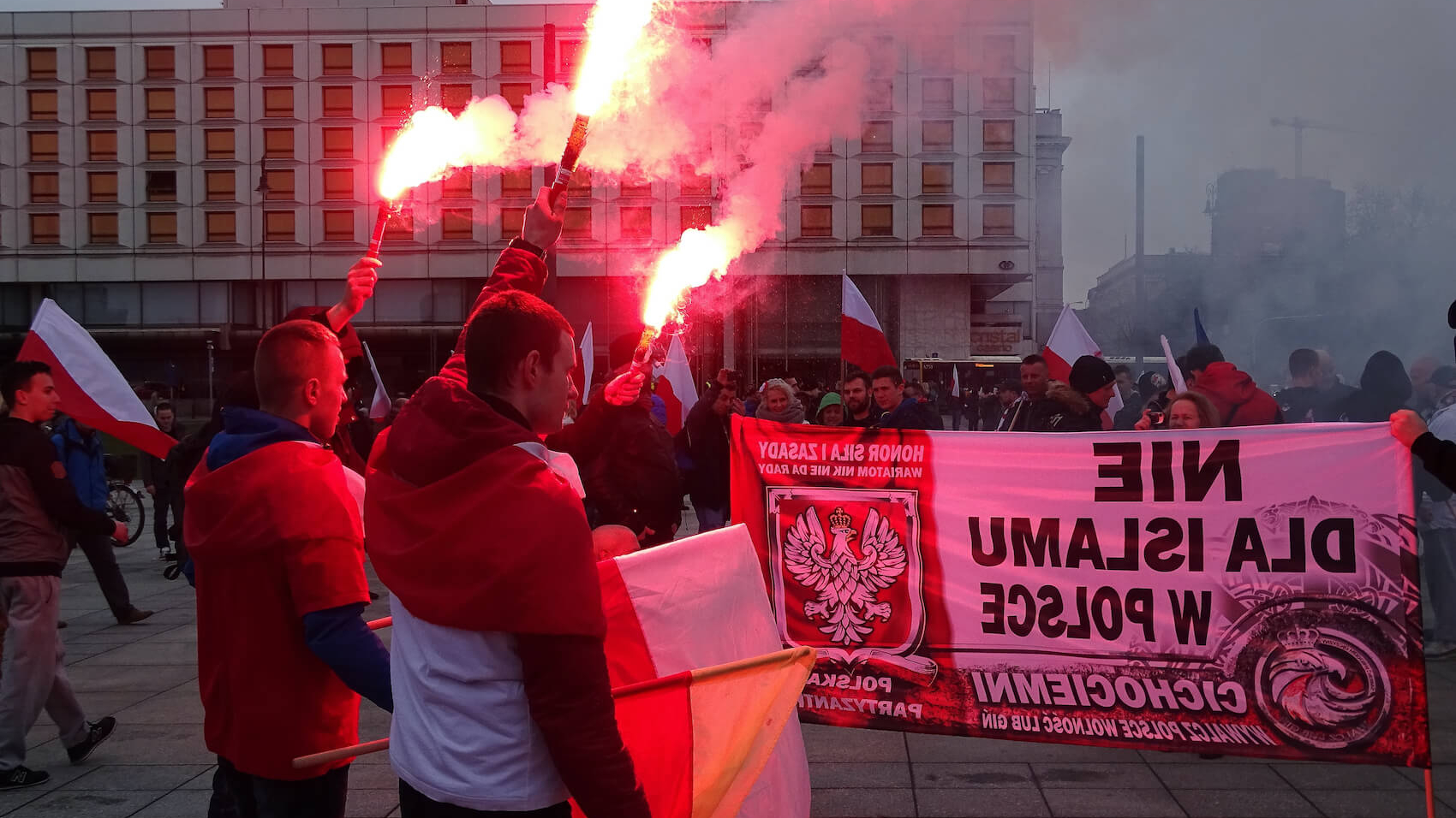 Participants of nationalist and anti-Islamic demonstration organized by far-right organisations use smoke races, hold banners in Warsaw, Poland on April 10, 2016. Photo: Wiola Wiaderek.