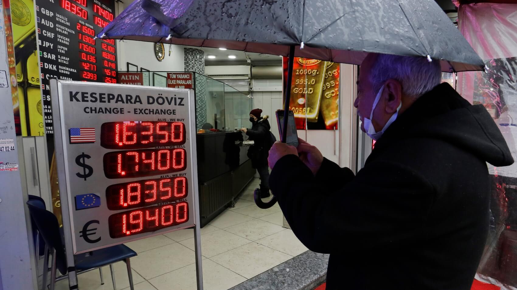 A man takes a picture of a foreign currency exchange board in Kadikoy district in Istanbul, Turkey. The Turkish Lira set a new record low rate trading at 16 against the US Dollar on December 18, 2021. Photo: Nelson Antoine.