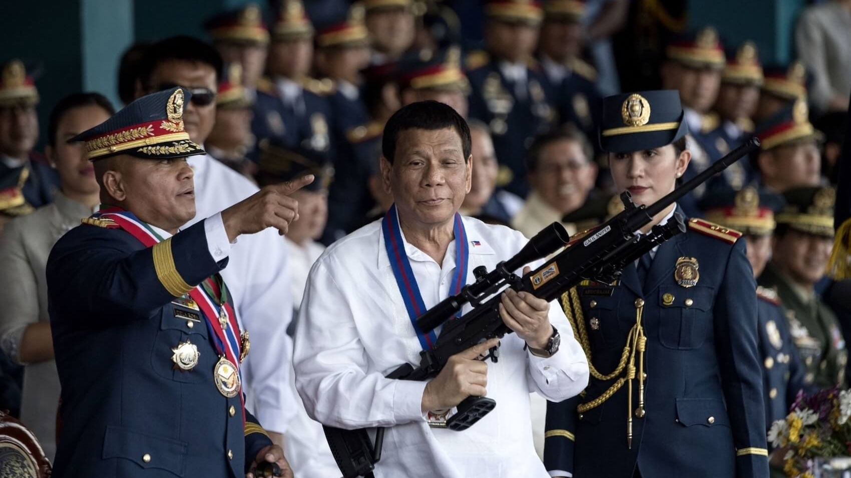 Former Philippine President Rodrigo Duterte holds a Galil sniper rifle with outgoing Philippine National Police (PNP) chief Ronald dela Rosa (L) at Camp Crame in Manila on April 19, 2018. Photo: Salma Bashir Motiwala.