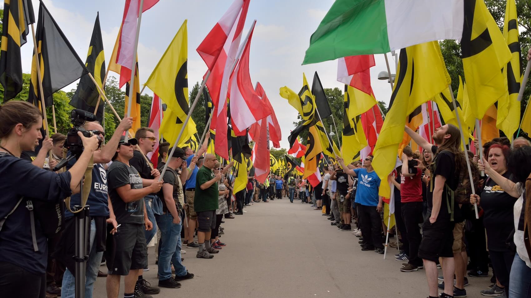 Demonstrators of the Austrian Identitarian movement form a guard of honor of flags in Vienna, Austria on June 11, 2016. Photo: Johanna Poetsch.