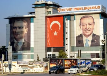A view of the AKP's Izmir Provincial Directorate. The Turkish flag, along with posters of Erdogan and Ataturk, are seen together on the front of the building on October 30, 2021, in Bayrakli, Izmir. Photo: Idil Toffolo.