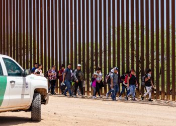 A group of migrants entered the U.S. from Mexico through an opening in the border fence near Sasabe, Arizona, and turned themselves in to a waiting CBP agent on July 15, 2023. Photo: Aaron Wells.