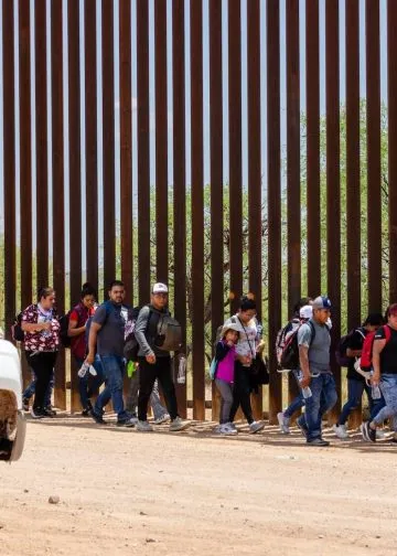 A group of migrants entered the U.S. from Mexico through an opening in the border fence near Sasabe, Arizona, and turned themselves in to a waiting CBP agent on July 15, 2023. Photo: Aaron Wells.
