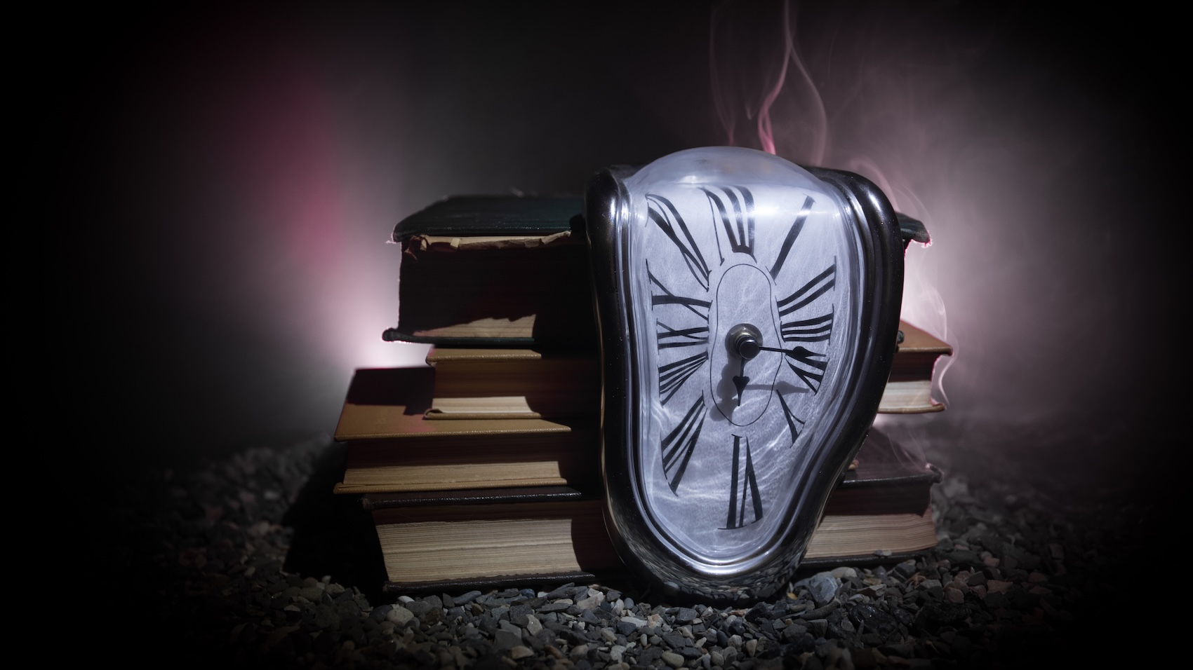Distorted soft melting clock on the old books. Photo: Zef Art.