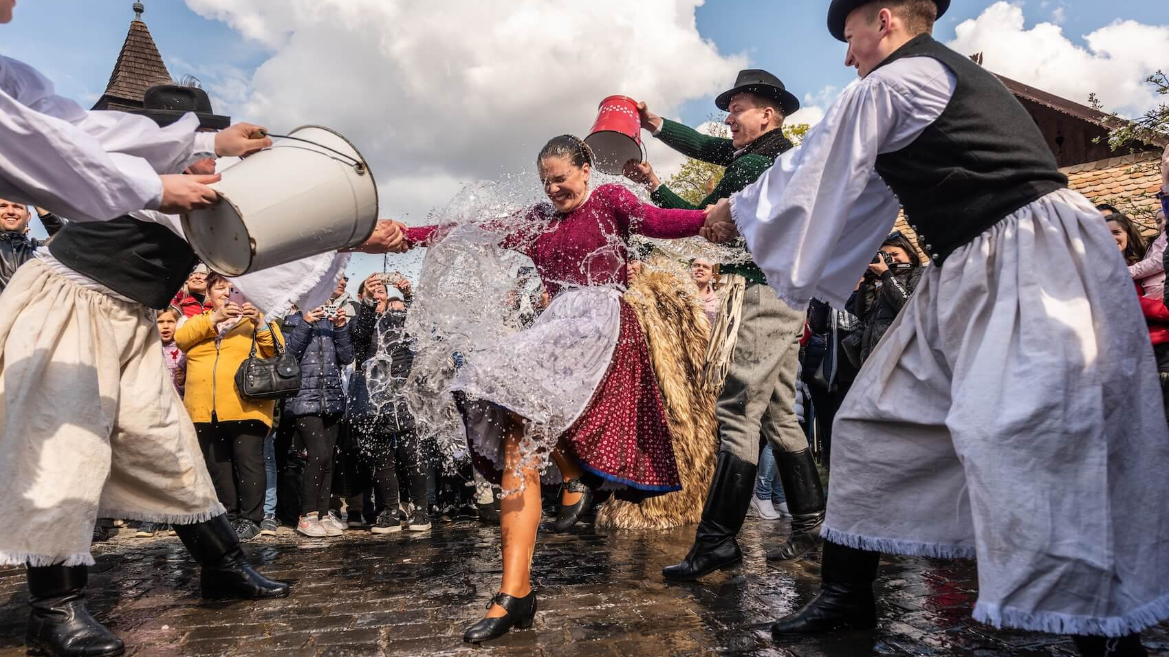 Easter festival in the folklore village of Hollókő, Hungary: On April 18, 2022, as part of the tradition, men sprinkle water on women in celebration. Photo: Shutterstock.