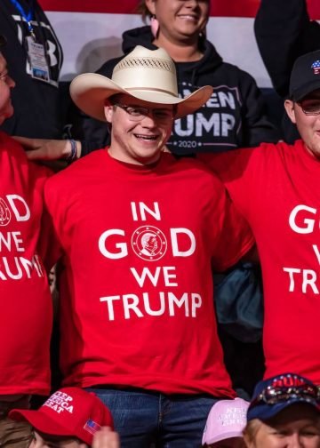 Donald Trump's supporters wearing "In God We Trump" shirts at a rally in Bojangles' Coliseum in Charlotte, North Carolina, on March 2, 2020. Photo: Jeffrey Edwards.