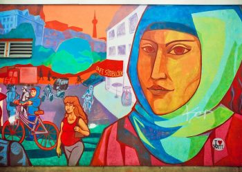 Urban graffiti depicting the face of a woman in a hijab, located in an immigrant-populated neighborhood on September 1, 2015. The urban area of Berlin, Germany—home to 4 million residents—ranks as the 7th most populous in the European Union. Photo: Dreamstime.