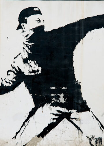 Banksy protest mural in Palestine. A mural by the artist Banksy on a wall in the West Bank village of Beit Sahour, June 18, 2014. Photo: Dreamstime.