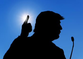 Silhouette of US President Donald Trump attending a conference. Photo: Dreamstime.