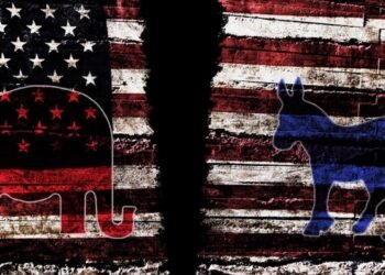 Torn American flag with Democratic and Republican party symbols, representing political division in the United States. Photo: Dreamstime.