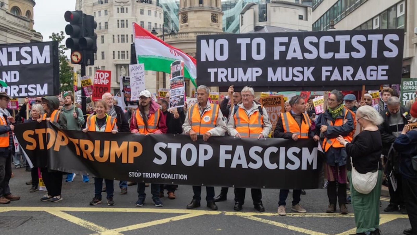 Stop Trump Coalition march, Central London, United Kingdom, September 17, 2025. A protester holds a sign reading “No to fascists — Trump, Musk, Farage.” Photo: Ben Gingell.