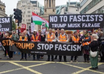 Stop Trump Coalition march, Central London, United Kingdom, September 17, 2025. A protester holds a sign reading “No to fascists — Trump, Musk, Farage.” Photo: Ben Gingell.