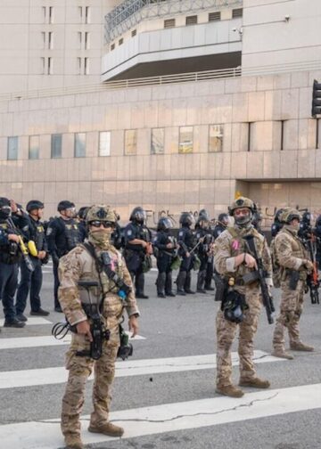 National Guard troops stand on standby during a downtown demonstration opposing expanded ICE operations and supporting immigrant rights in Los Angeles, United States, June 8, 2025. Photo: Brphoto | Dreamstime.