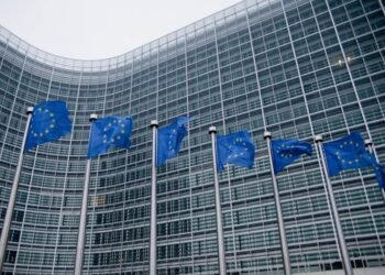 European Commission headquarters with waving EU flags in Brussels. Photo: Viorel Dudau.