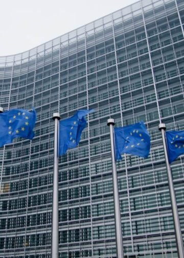 European Commission headquarters with waving EU flags in Brussels. Photo: Viorel Dudau.
