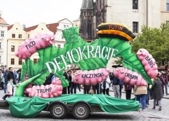 Labour Day celebrations at Old Town Square in Prague on May 1, 2017, featuring a banner depicting democracy as a leaf eaten by caterpillars labeled Putin, Kaczyński, Orbán, Babiš, Trump, and Fico.
Photo: Jolanta Wojcicka.