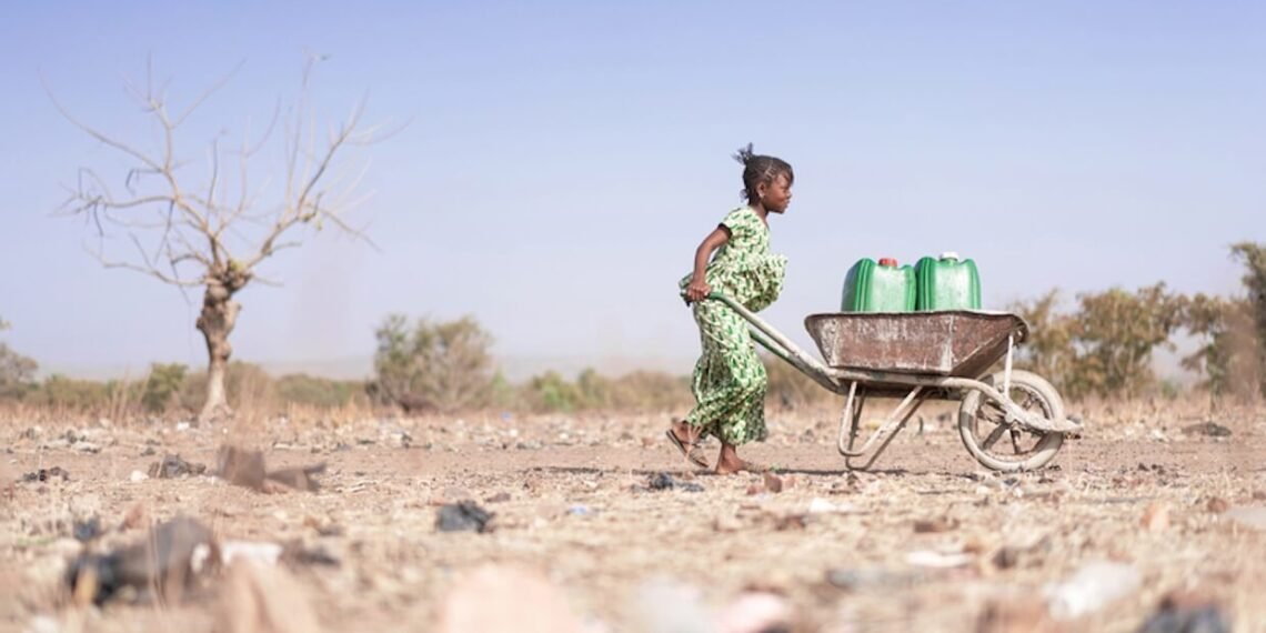 Young African woman carrying water.