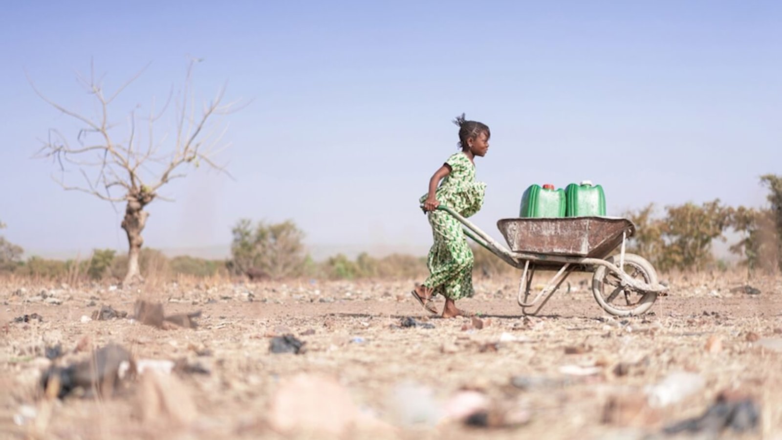 Young African woman carrying water.