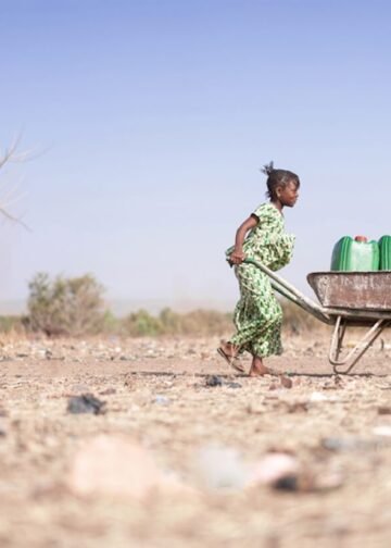 Young African woman carrying water.