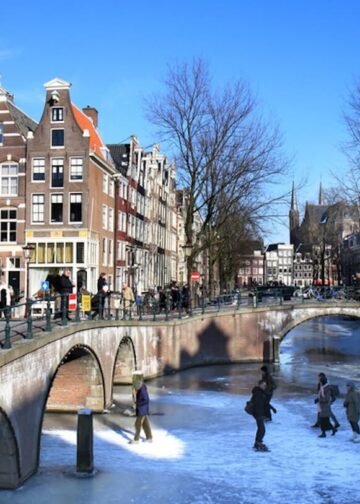 People skating on the frozen canals at the crossing of Leidsegracht and Keizersgracht in Amsterdam, the Netherlands. Amsterdam&rsquo;s canals rarely freeze, allowing residents and visitors to walk and skate on the ice. Photo: Wessel Cirkel.